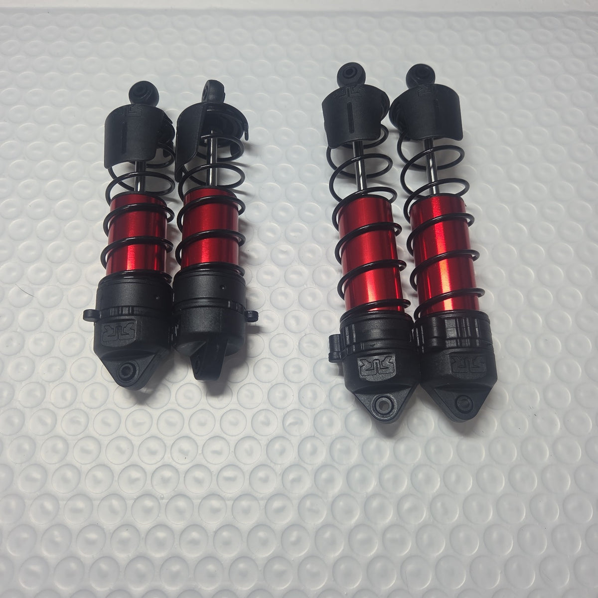 ARRMA Outcast 4S shock set front and rear view